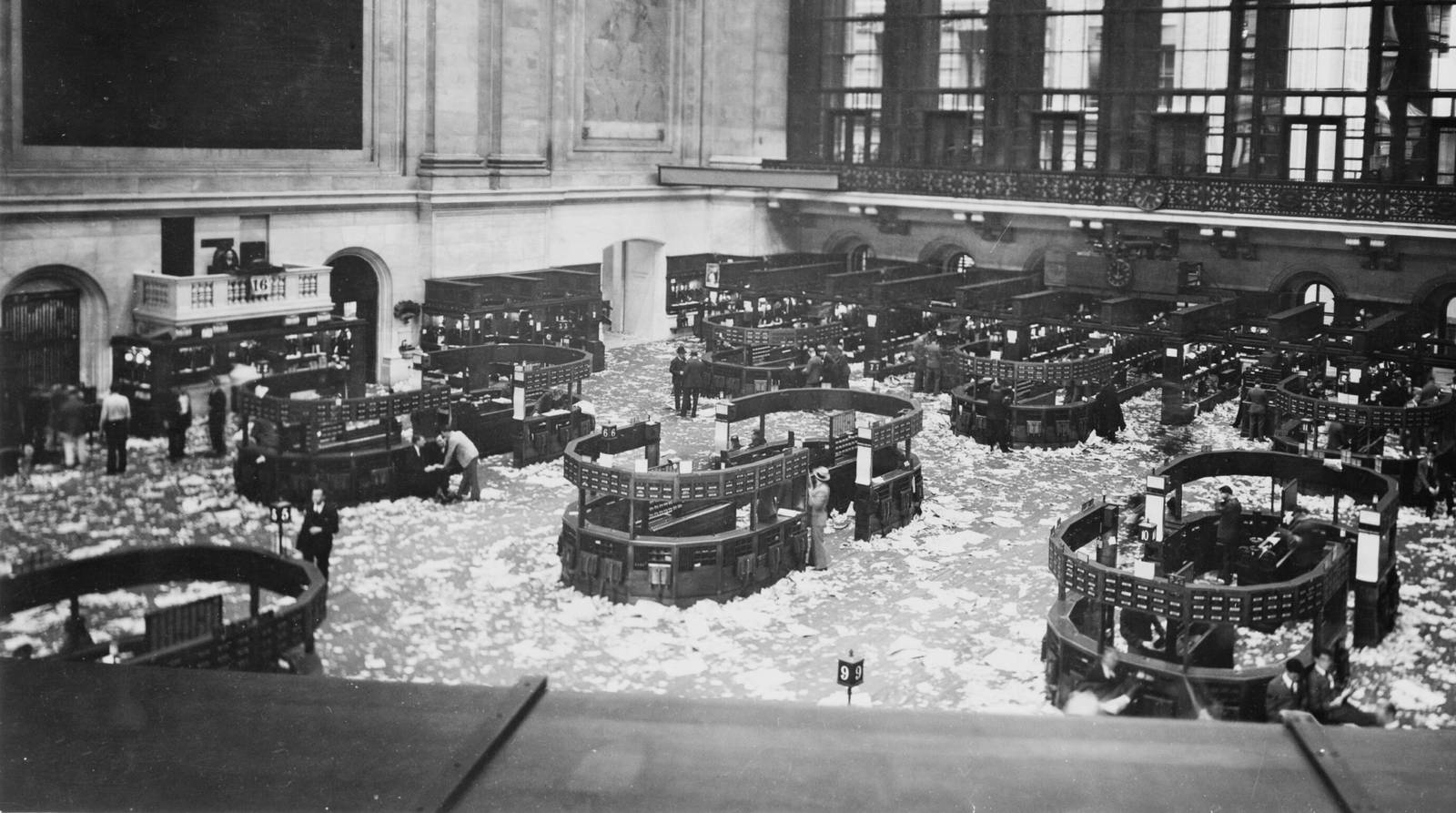 A stock exchange floor seen from above around 1920, the ground covered with order slips after the session